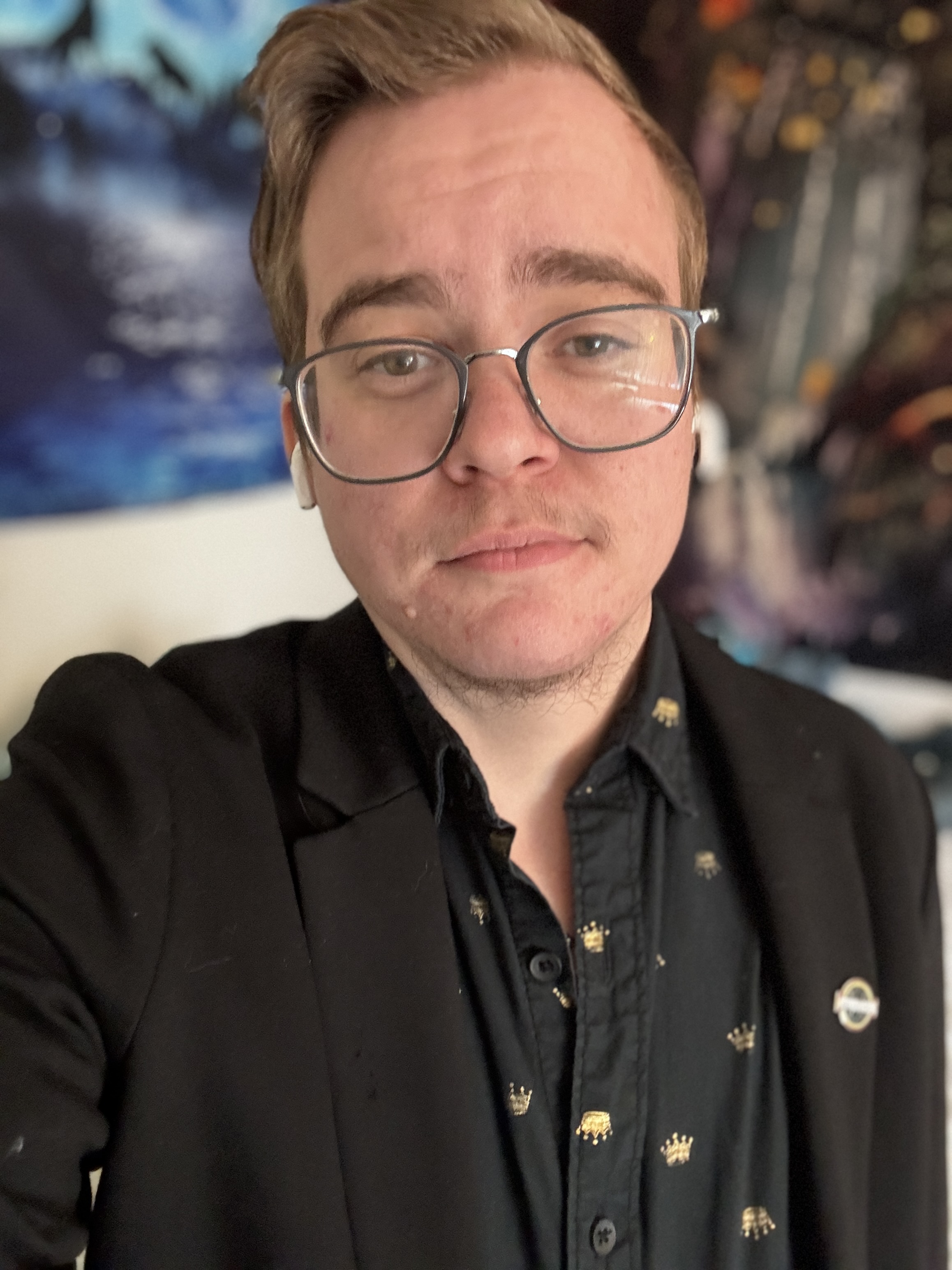 Photo of Harm Tarrant, a young white man with light brown hair and large rimmed glasses. He is wearing a black button up shirt. Text next to his photo says "Welcome Harm Tarrant. He/Him. Harm is APRIL's new Youth Advisory Specialist".