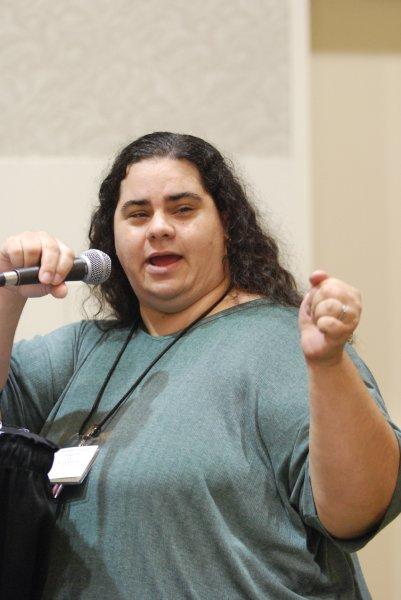 lady focused on sharing a needed point and holding a microphone